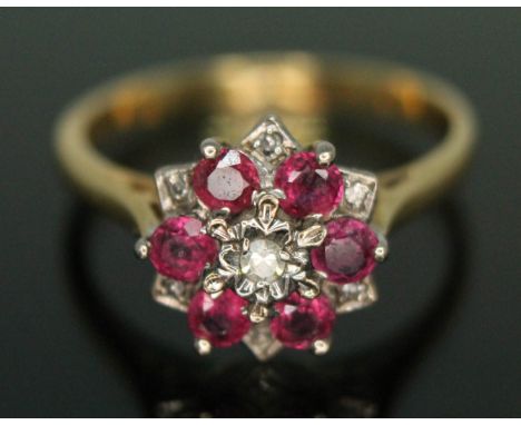 A ruby and diamond cluster ring, the star cluster measuring approx. 10mm x 10mm, band marked '18ct', gross wt. 3.28g, size N.