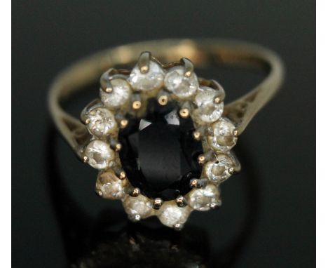 A hallmarked 9ct gold sapphire and CZ cluster ring, gross wt. 2.25g, size N.  Condition - a build up of dirt around setting, 
