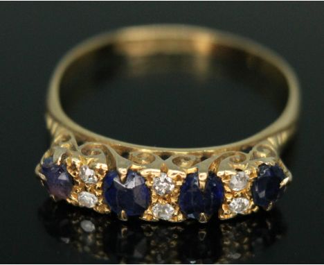 An early 20th century diamond and sapphire ring, the stones within scroll setting, hallmarked 18ct gold band, Birmingham 1912