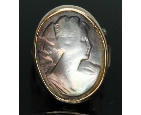 A mother of pearl doublet cameo ring, band unmarked, gross wt. 5.65g, size M.  Condition - part of the black backing has come