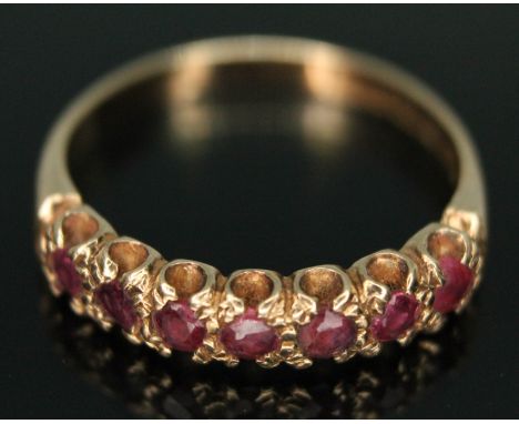 A hallmarked 9ct gold seven stone ruby ring, gross wt. 2.30g, size N.  Condition - line to back of band indicating re-sizing,