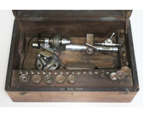 An old watch and clock maker's lathe, fitted in box with accessories.  