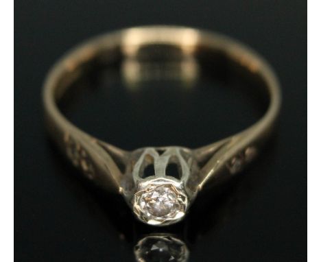 A diamond solitaire, the modern round brilliant cut diamond weighing approx. 0.10 carats (estimated), diamond set shoulders, 