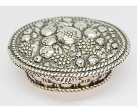 A German silver trinket box modelled as a basket of fruit with gilt interior, length 74mm, weight 74.05g.  Condition - good, 