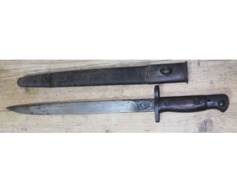 A British GRI Mk. I bayonet with RFI stamp (Rifle Factory Ishapore), dated 11 42 (November 1942) with steel mounted leather s