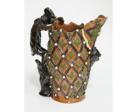 A lattice moulded art pottery jug with figural handle, Edward Bingham for Castle Hedingham pottery, impressed marks to base, 