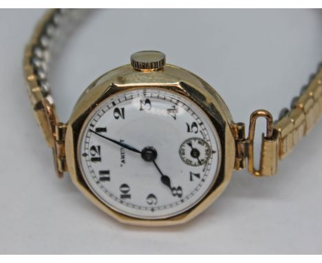 A hallmarked 9ct gold ladies wristwatch, the white enamel dial signed 'Akurit' and having Arabic numerals, spade hands and se