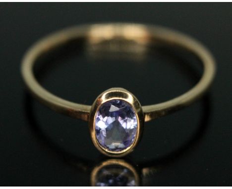 A hallmarked 9ct gold bezel set tanzanite ring, gross wt. 1.00g, size P.  Condition - good, general wear only.