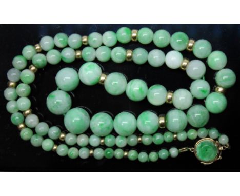 A single strand of graduated jadeite jade beads, ranging in diameter from 4mm to 11mm, spaced with twenty yellow metal beads,