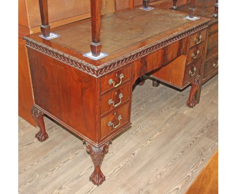 An Edwardian Chippendale style mahogany knee hole desk with cedar lined drawers, width 125cm, depth 64cm &amp; height 79cm.  