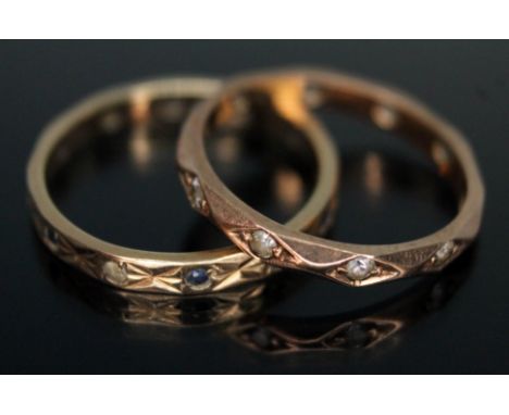 A hallmarked 9ct gold eternity ring set with sapphires and colourless stones, together with another set with colourless stone