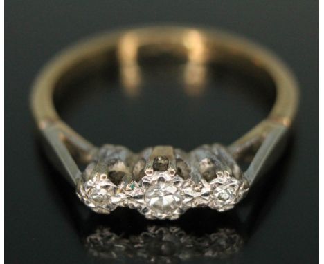 A three stone diamond ring, the band marked '18ct PLAT', gross wt. 2.03g, size K.  Condition - good, minor wear only.