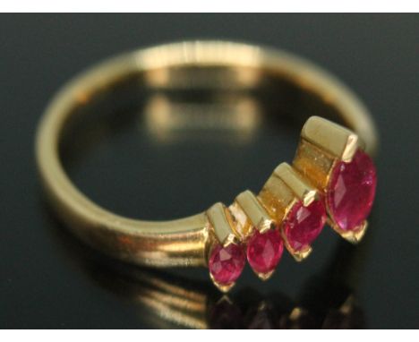 A wishbone ring set with four marquis cut rubies, band marked '750', gross wt. 2.82g, size L/M.  Condition - good, general we