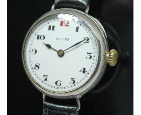 A silver cased WWI era trench style Rolex wristwatch having signed white enamel dial with Arabic numerals and spade hands, th