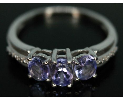 A three stone tanzanite ring, marked '375', gross wt. 2.35g, size P.  Condition - good, general wear.