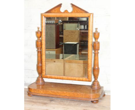 A 19th century bird's eye maple toilet mirror with architectural cornice, turned supports and platform base, width 73cm, dept