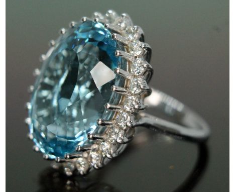 A topaz and diamond cocktail ring, the light to medium oval mixed cut blue topaz weighing approx. 28.89 carats (calculated), 