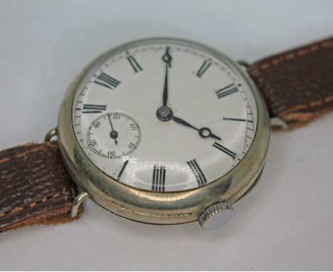 A nickel plated trench style wristwatch with unsigned white enamel dial having Roman numerals, breguet hands and seconds subs