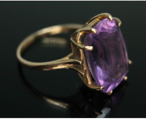 A hallmarked 9ct gold ring, the basket set rectangular cut amethyst weighing approx. 11 carats, gross wt. 4.84g, size N.  Con