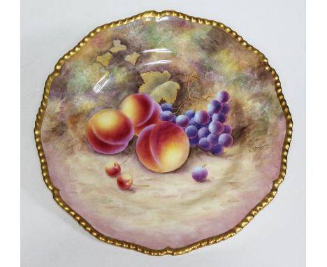 A Royal Worcester porcelain cabinet plate with hand painted decoration depicting fruit signed J Skerrett, gadrooned and gilt 