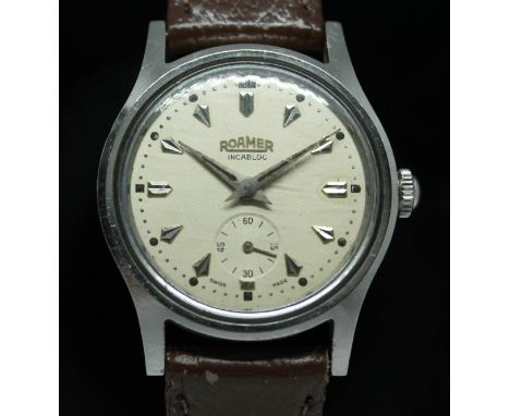 A vintage stainless steel Roamer manual wind wristwatch with signed champagne dial, silver tone hour indices and sword hands 