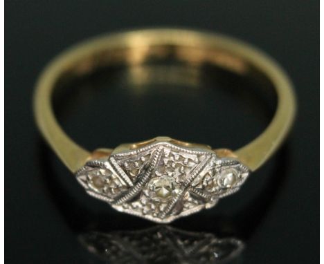 An Art Deco three stone diamond ring, the head measuring approx. 12mm x 6mm, band marked '18ct PLAT', gross wt. 2.15g, size M