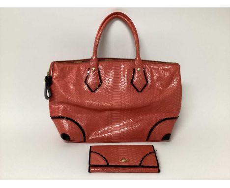 Vintage Vivienne Westwood pink faux snakeskin handbag and matching purse, both with gold tone logo metal orb. Handbag has bla