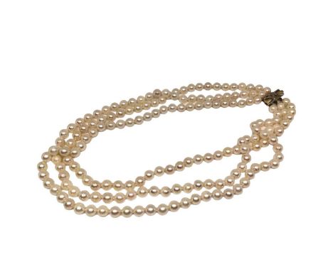 Cultured pearl necklace with a triple strand of 6- 6.5mm cultured pearls on a 14ct gold and diamond clasp, approximately 39cm