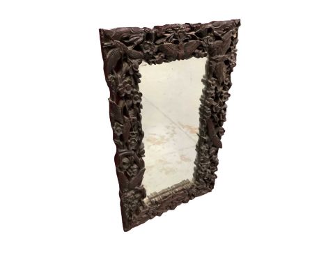 Early 20th century Chinese carved hardwood wall mirror, pierced and carved in high relief with moths and foliage, 67 x 41cm
