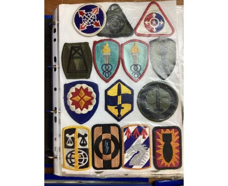 Four albums of American Air Force, US Army and US Navy military cloth and metal badges (4 albums)
