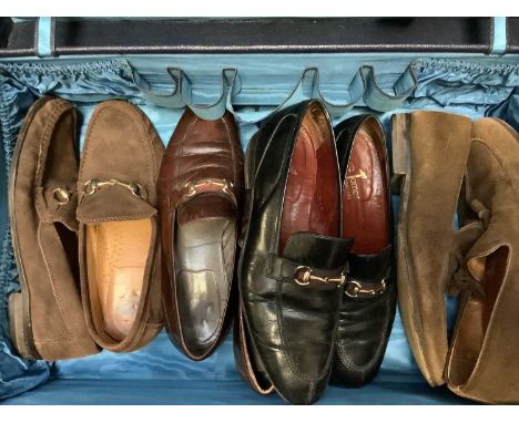 A leather case of men's vintage accessories including shoes with horse bit trim, three straw hats and one felt hat, waistcoat