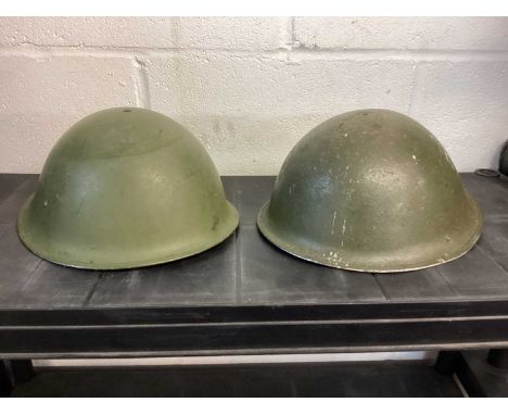 Second World War British military MK III steel helmet with green camouflage finish, with liner and chin strap, dated 1945 to 