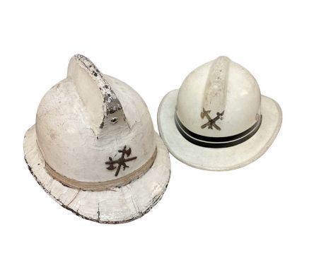 French Fire Brigade cork helmet with white painted canvas covering, together with another white painted Fire Brigade helmet (