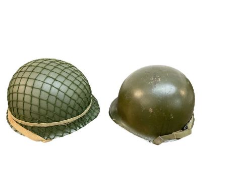 American M1 steel helmet complete with liner, chinstrap and netting cover, together with another American M1 steel helmet (2)