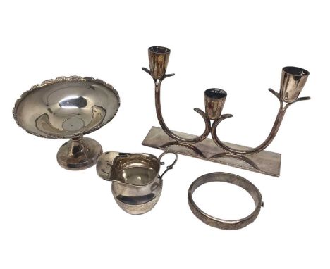 Silver pedestal bonbon dish, small silver cream jug, silver bangle and a plated three branch candlestick