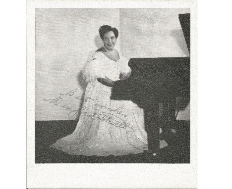 Winifred Atwell signed 5 x 5 portrait photo sitting in long white dress at the piano. Comes with biography information. Good 