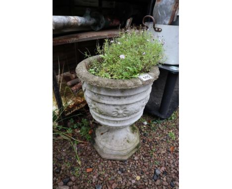 Stone planter on stand with plant