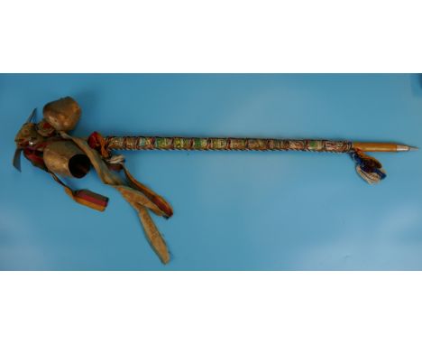 Wooden stick with spike, pick and cow bells