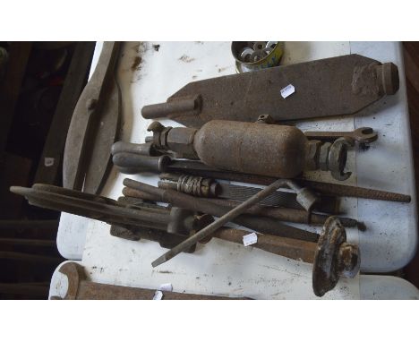 A collection of various tools to include files, a plate and a bracket.