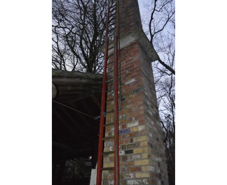 An iconic red painted wooden steeplejack ladder, with metal rung strengtheners and 21 rungs, with a further six rung example 
