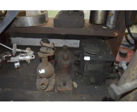 Two jacks, a bracket and a hydraulic fitting. 
