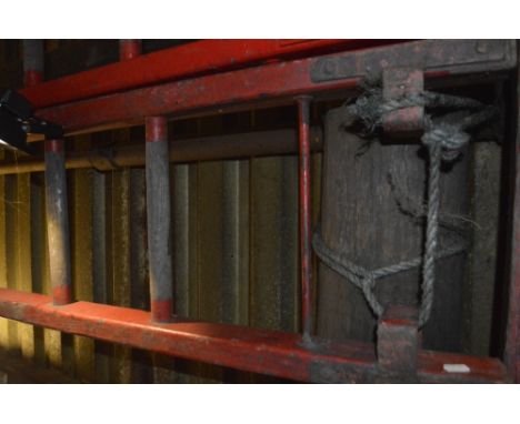 An iconic red painted wooden steeplejack ladder, with metal rung strengtheners and 21 rungs (strictly for decorative purposes