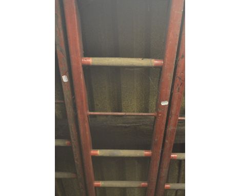An iconic red painted wooden steeplejack ladder, with metal rung strengtheners and 21 rungs (strictly for decorative purposes