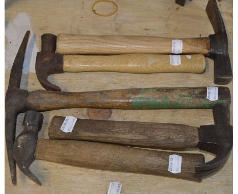 Four wooden handled hammers, each approx. 10", and a pick axe (5).