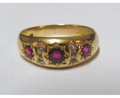 An 18ct three stone ruby and diamond ring, size R 6.3g