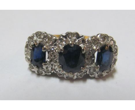 An 18ct three stone sapphire and diamond ring, size M 4.4g