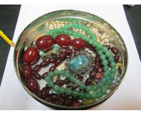 An amber style necklace, jade style beaded necklace with silver clasp, other necklaces and a bracelet