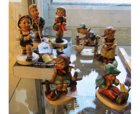 Seven Hummel figures and a book