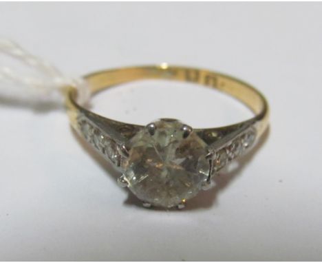 A solitaire diamond ring with illusion shoulders on gold and platinum band, approximately one carat spread, size M 2.2g would