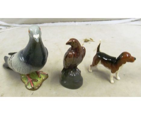 A Beswick dog, Scotch Whisky eagle and another bird